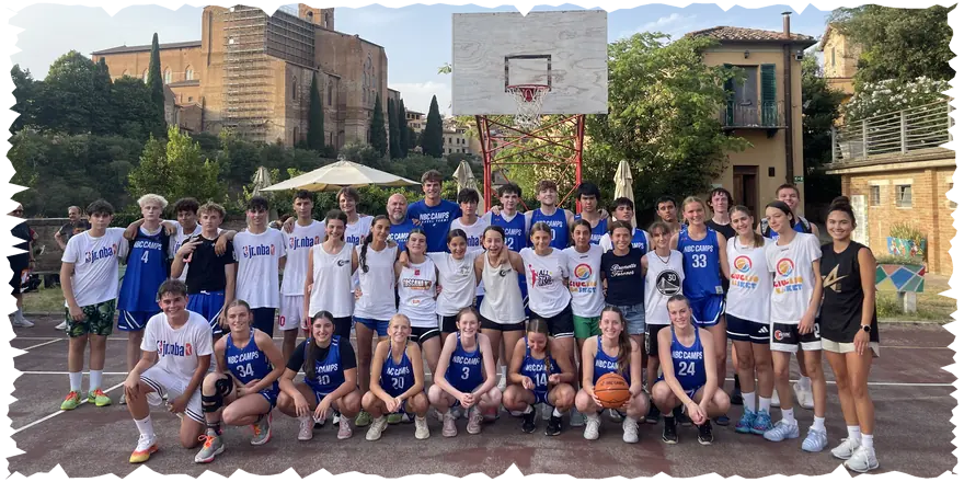 NBC Camps basketball teams on an outdoor court in Siena during their July 2026 tour in Italy
